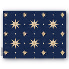 Stars Christmas tablecloth in navy and gold, folded on white, showing gold eight-pointed stars