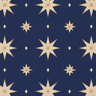 Close-up of the Stars Christmas tablecloth print in navy and gold on cotton, showing gold eight-pointed stars
