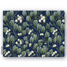 Navy Mistletoe Christmas tablecloth folded on white, showing sprigs of mistletoe with white berries