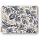 Pine Bough Christmas tablecloth in navy on ivory, folded on white, showing pine boughs and cones