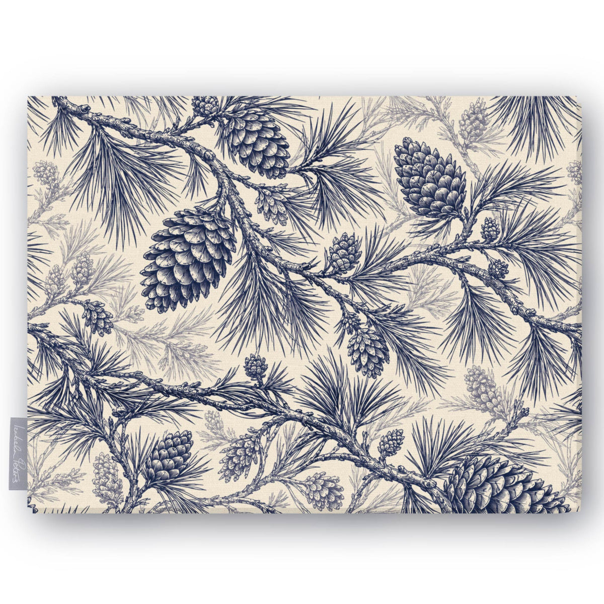 Pine Bough Christmas tablecloth in navy on ivory, folded on white, showing pine boughs and cones