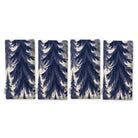 Spruce Stand Christmas napkins in navy on ivory, set of four, folded on white, showing the same spruce trees