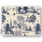 Village Toile Christmas tablecloth in navy on ivory, folded on white, showing a snowy village with a church and cottages
