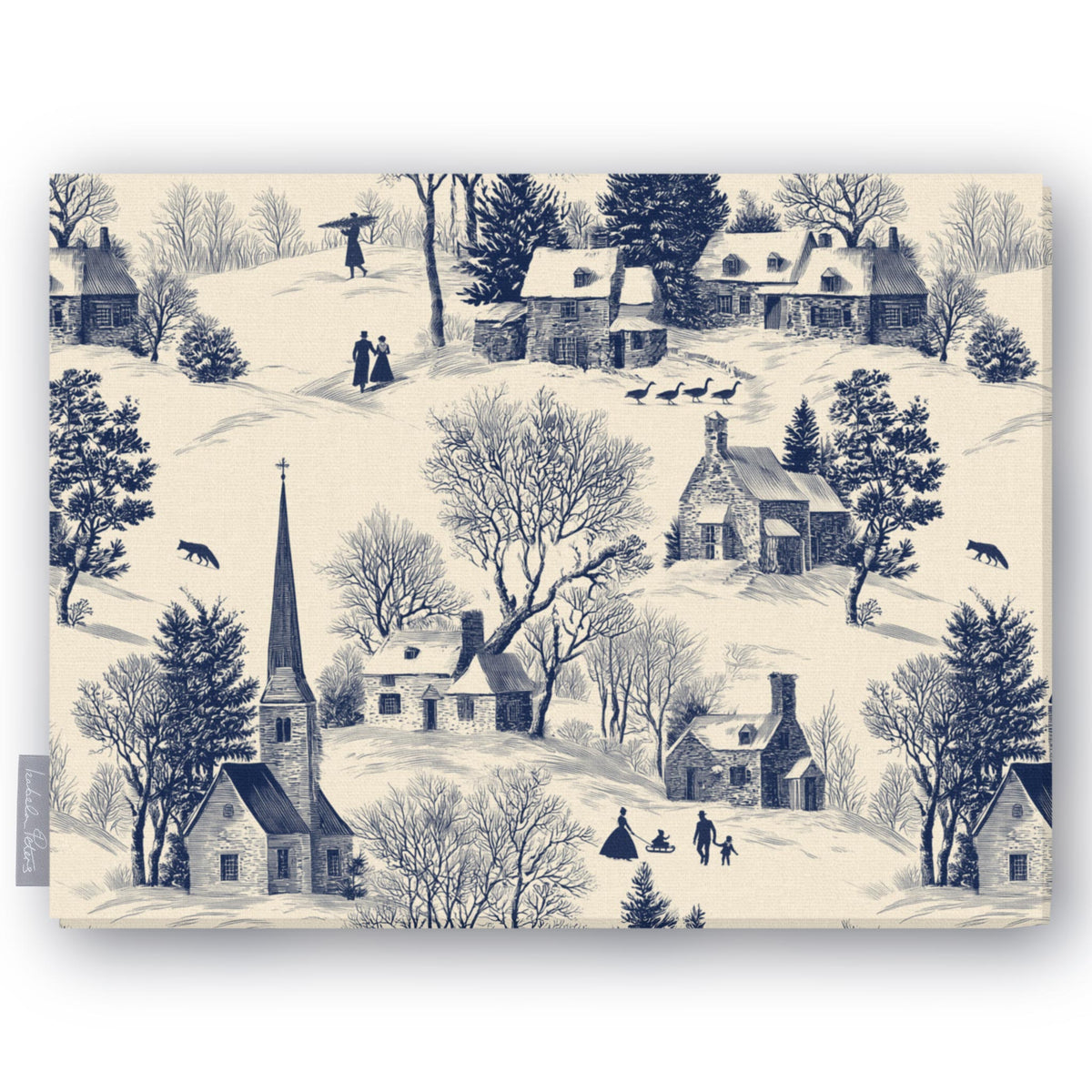 Village Toile Christmas tablecloth in navy on ivory, folded on white, showing a snowy village with a church and cottages