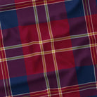 Close-up of the navy tartan Christmas tablecloth, showing the navy and burgundy check and fine ivory and gold lines