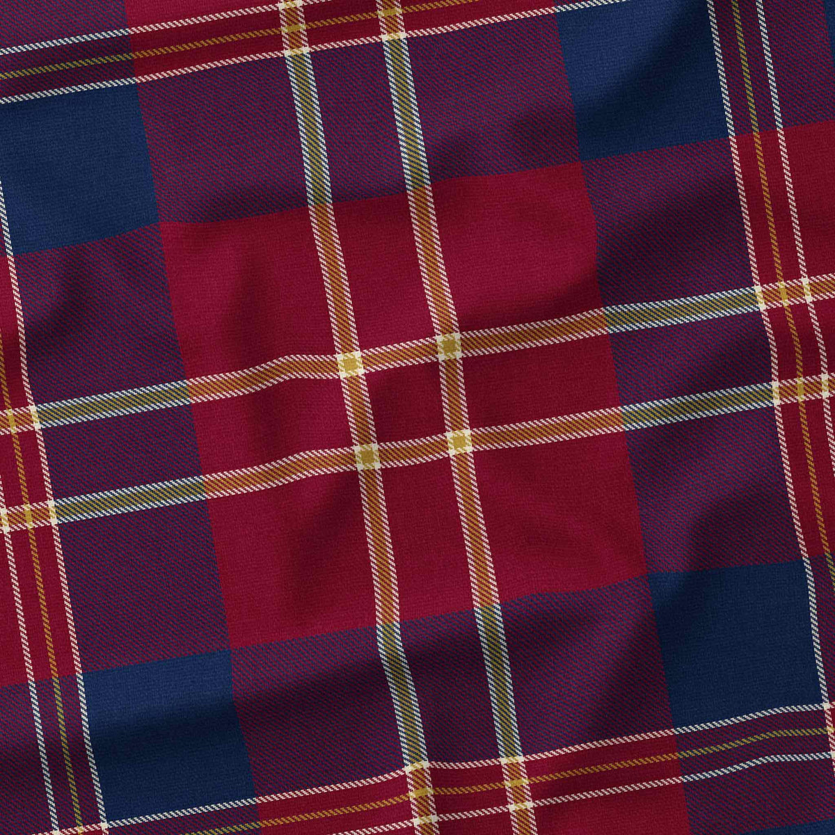 Close-up of the navy tartan Christmas tablecloth, showing the navy and burgundy check and fine ivory and gold lines