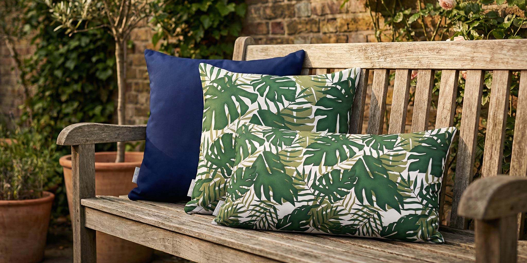 Waterproof outdoor cushions styled on a wooden garden bench
