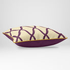 Angled view showing the front and Rich Plum plain reverse of a Palace Trellis rectangular cushion in Plum & Saffron, finished with Saffron piping.
