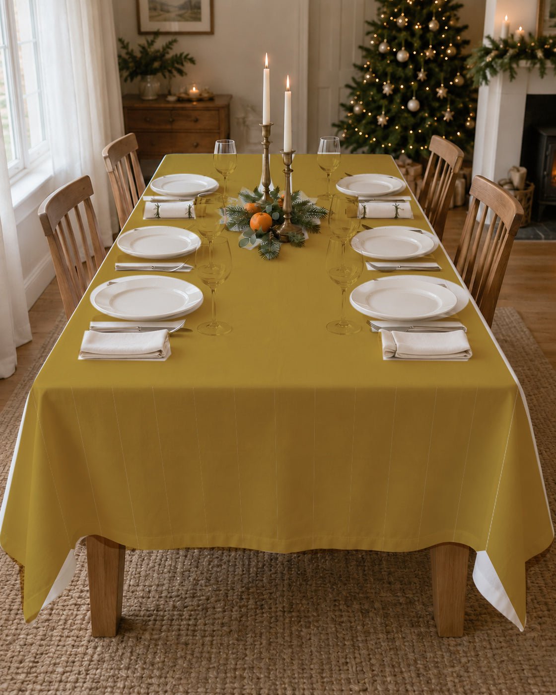 Plain gold Christmas tablecloth on a laid table