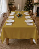 Plain gold Christmas tablecloth on a laid table