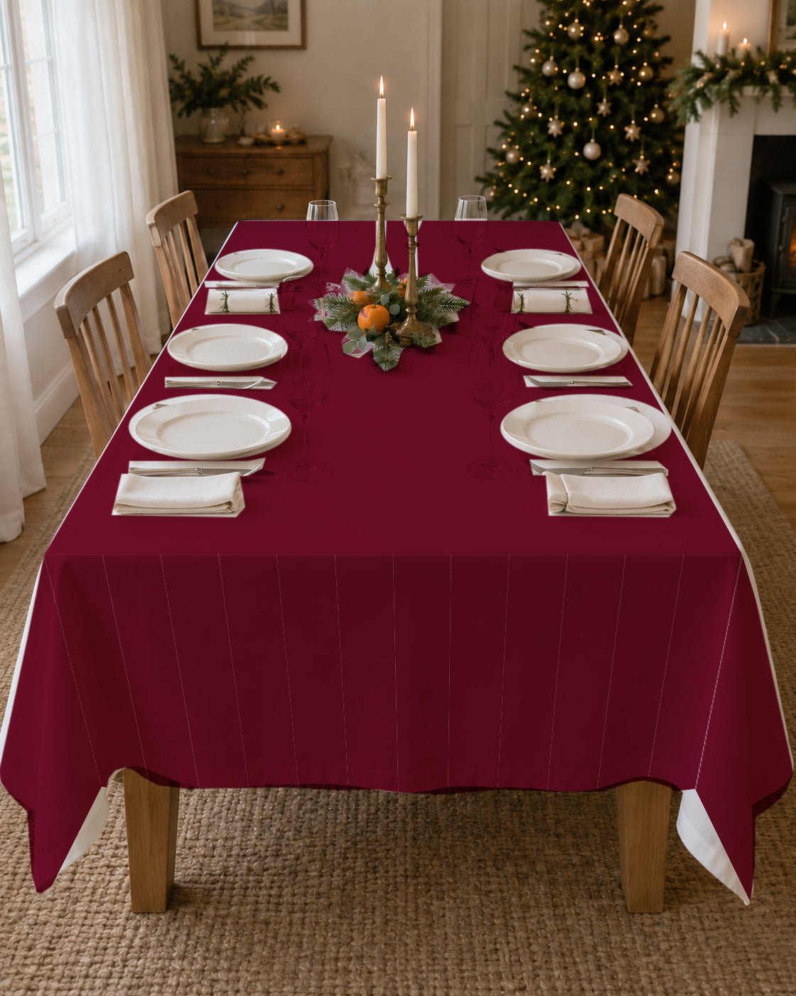 Plain burgundy Christmas tablecloth on a laid table
