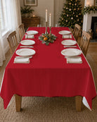 Plain red Christmas tablecloth on a laid table