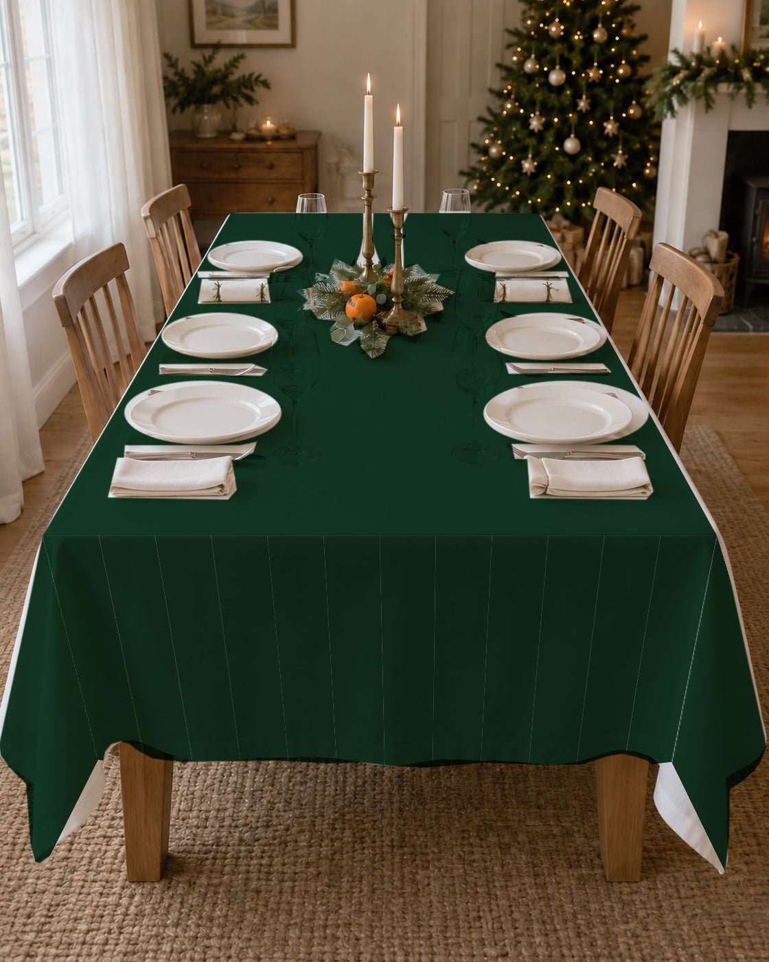 Plain green Christmas tablecloth on a laid table