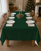 Plain green Christmas tablecloth on a laid table