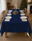 Plain navy Christmas tablecloth on a laid table