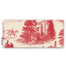 Fir Forest Toile Christmas table runner in red on ivory, folded on white, showing a rider on horseback among fir trees