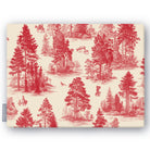 Fir Forest Toile Christmas tablecloth in red on ivory, folded on white, showing fir trees, a rider and figures in the forest