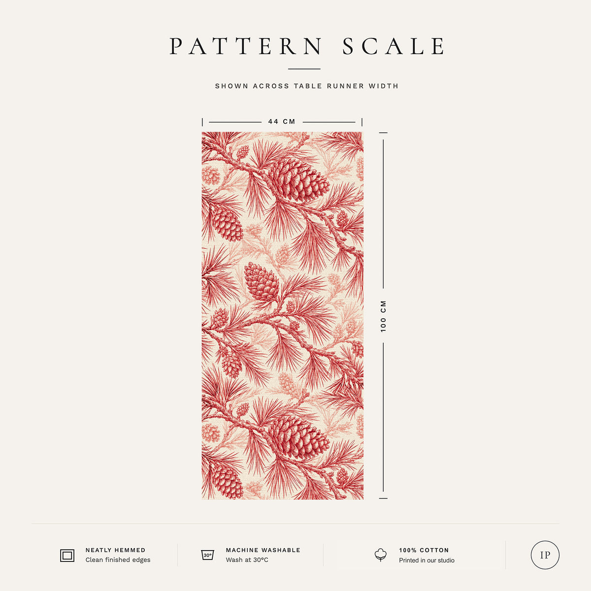 Pattern scale of the Pine Bough Christmas table runner in red on ivory across its 44 cm width, with care notes