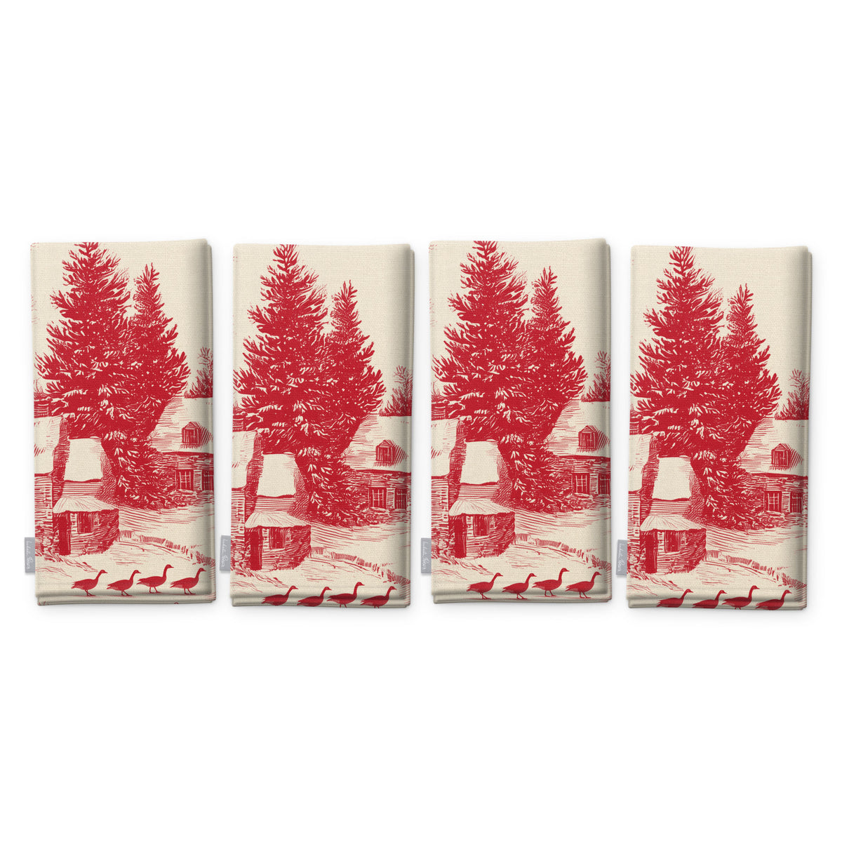 Village Toile Christmas napkins in red on ivory, set of four, folded on white, showing the same fir tree and snowy cottage