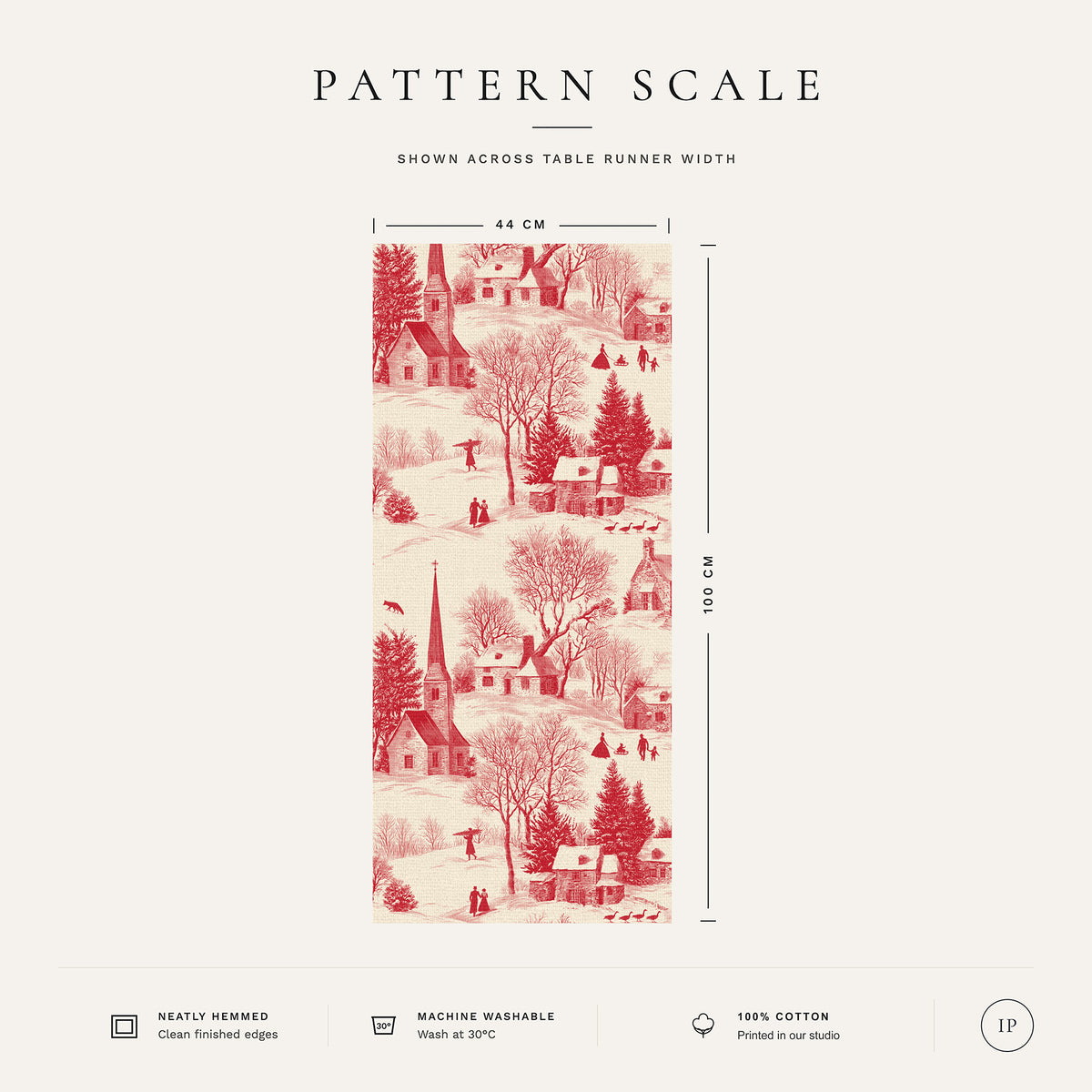 Pattern scale of the Village Toile Christmas table runner in red on ivory across its 44 cm width, with care notes