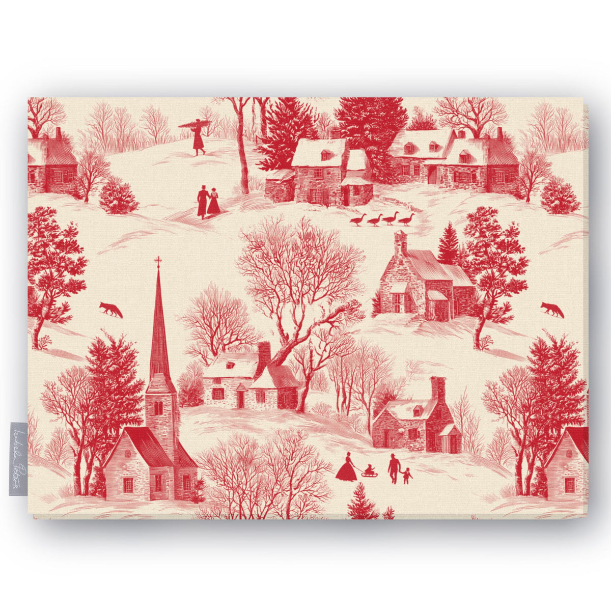 Village Toile Christmas tablecloth in red on ivory, folded on white, showing a snowy village with a church and cottages