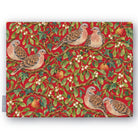 Red Turtle Doves and Mistletoe Christmas tablecloth folded on white, showing turtle doves among mistletoe and red apples