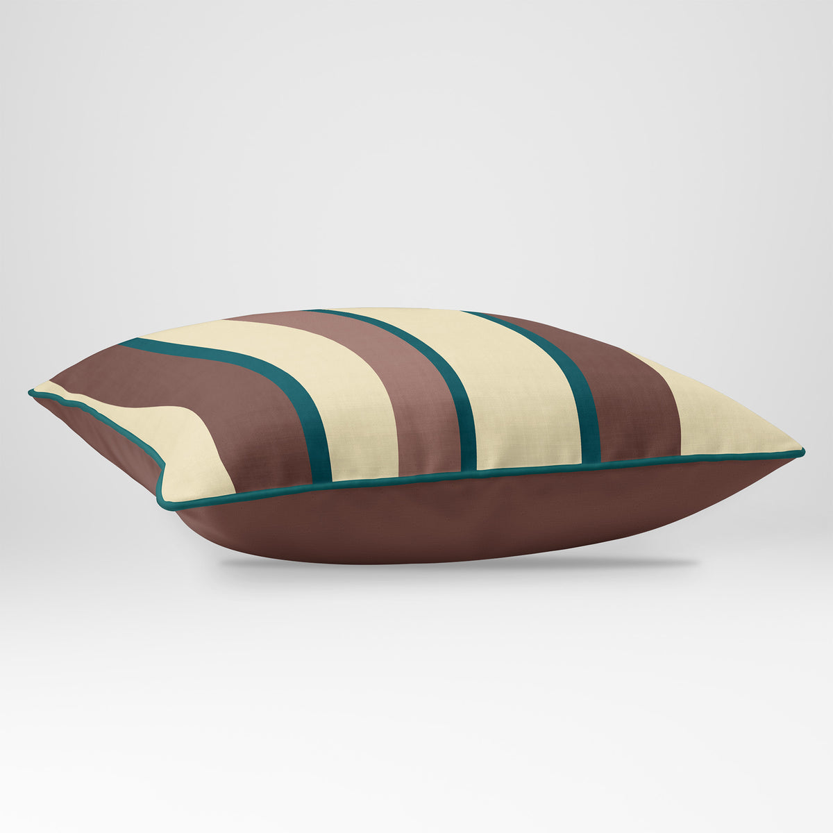 Angled view showing the front and Cocoa plain reverse of a Ribbon Stripe rectangular cushion in Cocoa & Teal, finished with Deep Teal piping.