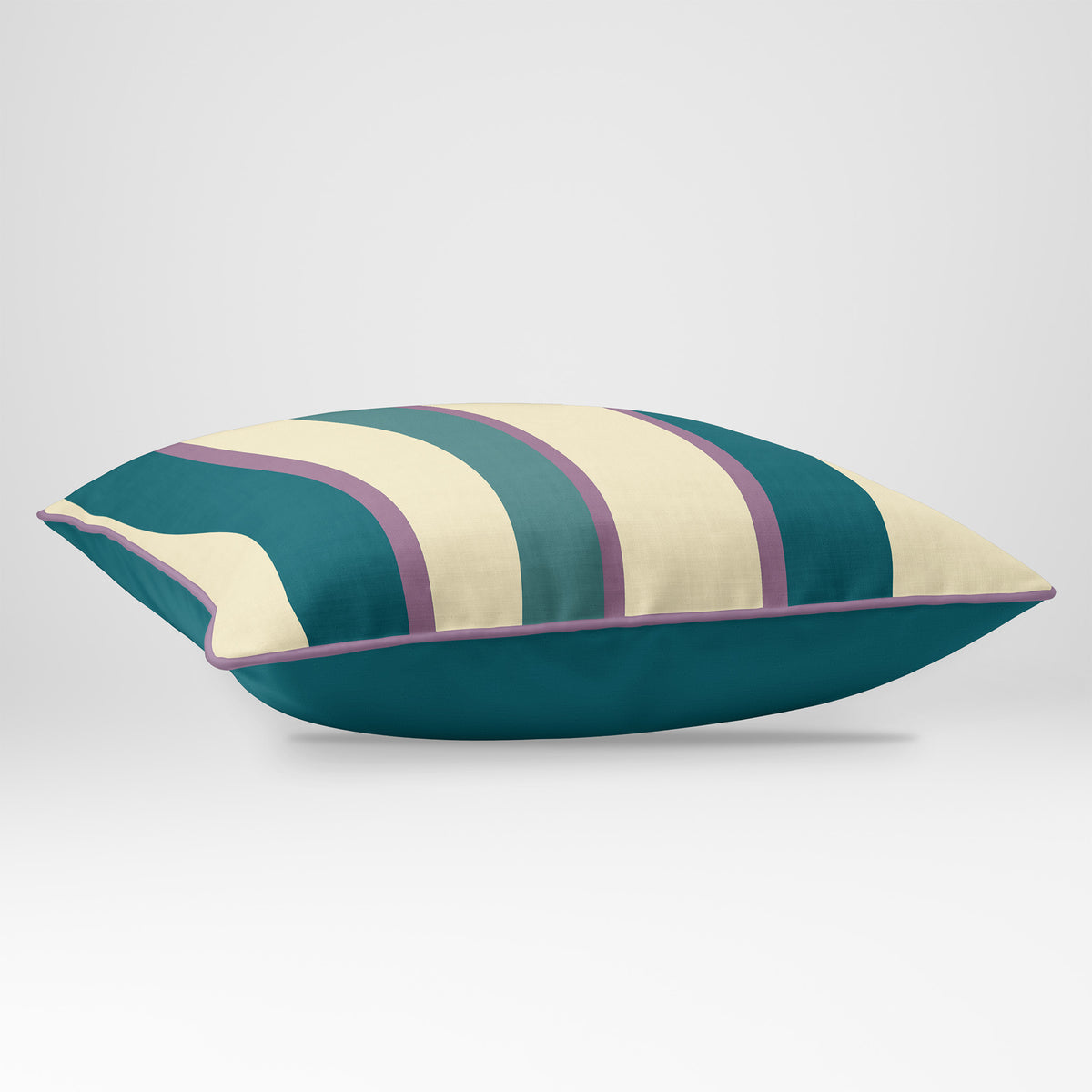 Angled view showing the front and Ink Blue plain reverse of a Ribbon Stripe rectangular cushion in Ink Blue & Lilac, finished with Muted Lilac piping.