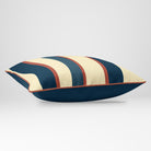 Angled view showing the front and Deep Teal plain reverse of a Ribbon Stripe rectangular cushion in Teal & Persimmon, finished with Persimmon piping.
