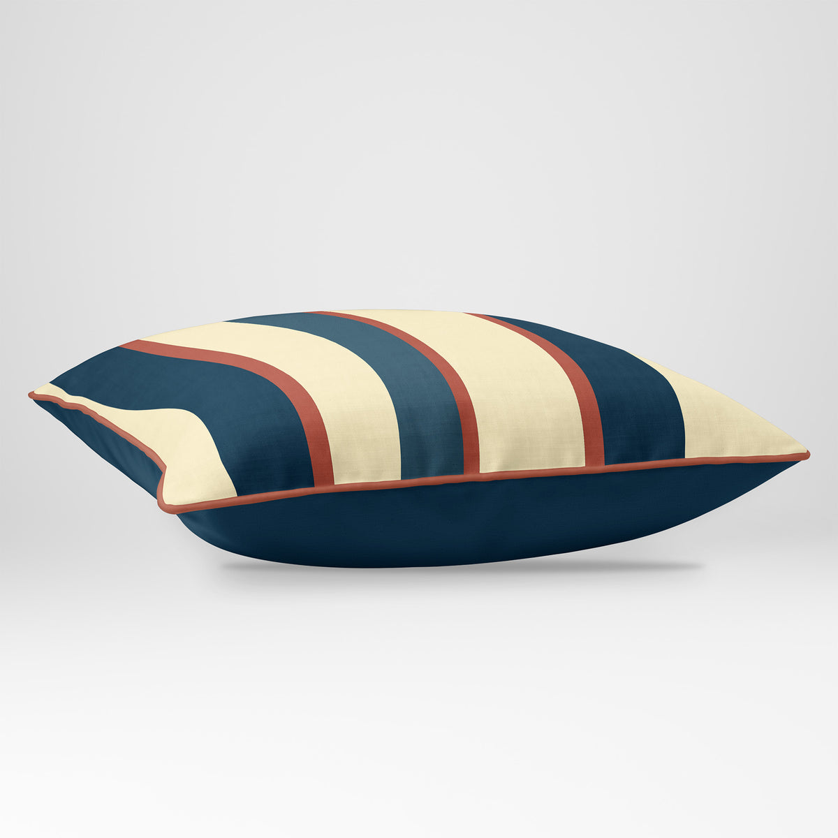 Angled view showing the front and Deep Teal plain reverse of a Ribbon Stripe rectangular cushion in Teal & Persimmon, finished with Persimmon piping.