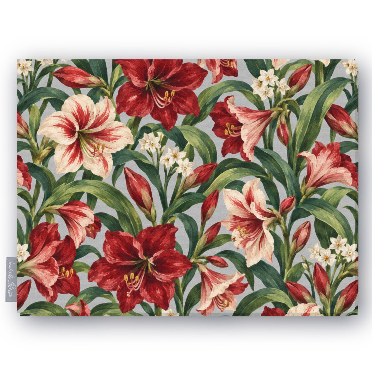 Amaryllis Christmas tablecloth in silver grey, folded on white, showing amaryllis flowers among long leaves