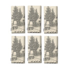 Village Toile napkins in silver grey on ivory, set of six, folded on white, showing the same fir tree and snowy cottage