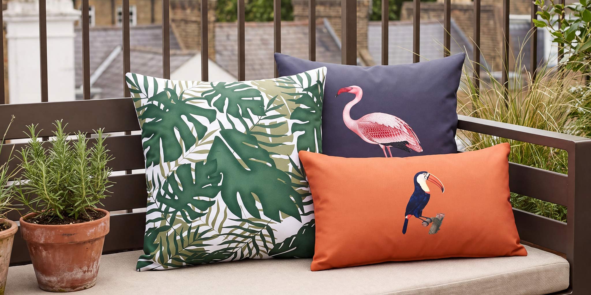 Palm leaf, flamingo and toucan outdoor cushions styled on a London roof terrace