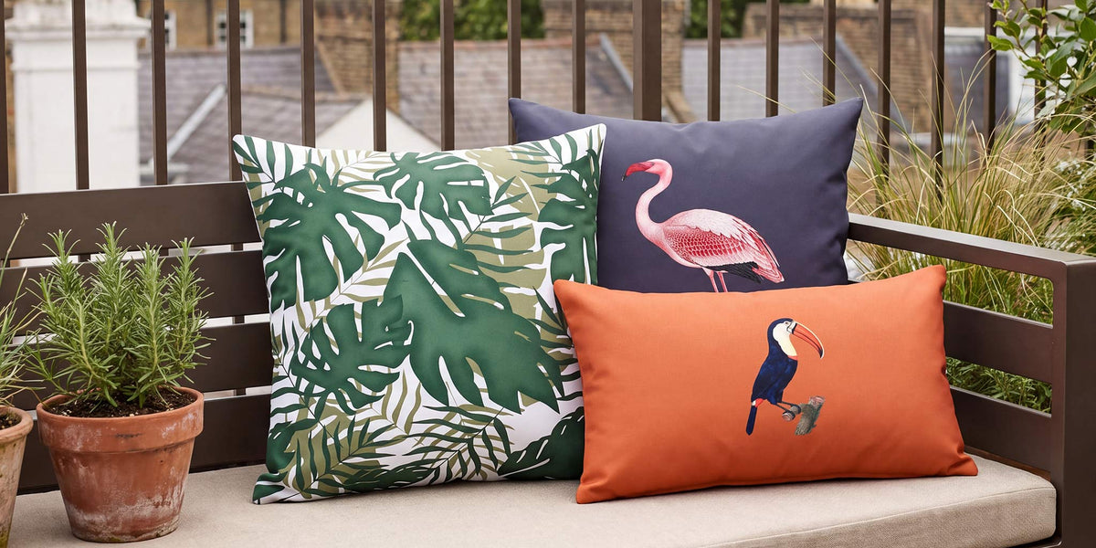 Palm leaf, flamingo and toucan outdoor cushions styled on a London roof terrace