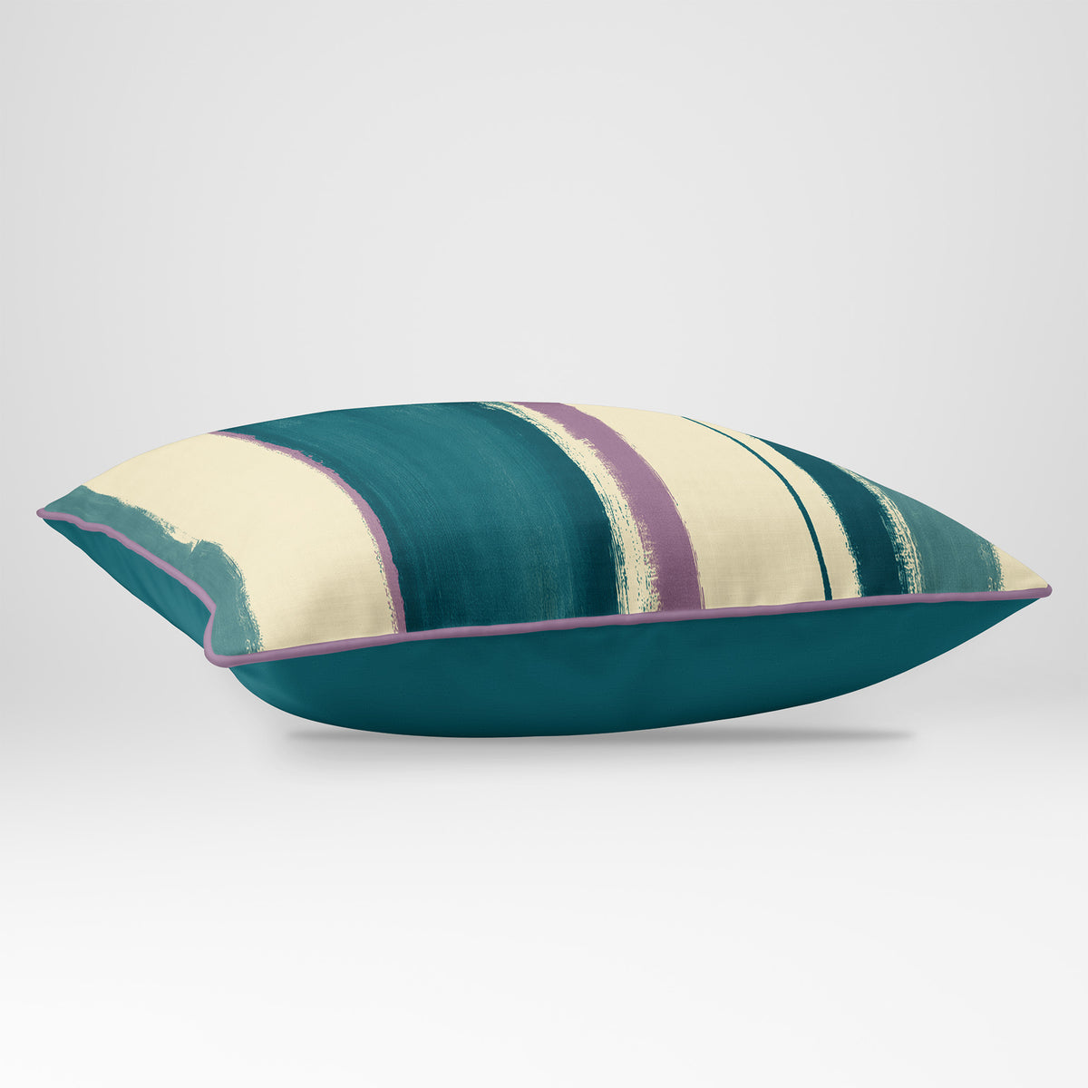Angled view showing the front and Ink Blue plain reverse of an Unequal Stripe rectangular cushion in Ink Blue & Lilac, finished with Muted Lilac piping.