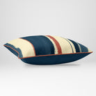 Angled view showing the front and Deep Teal plain reverse of an Unequal Stripe rectangular cushion in Teal & Persimmon, finished with Persimmon piping.