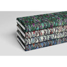Floral Meadow velvet fabric in Violet On Shades Of Forest Green
